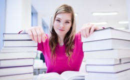 in the library – pretty, female student with laptop and books wo