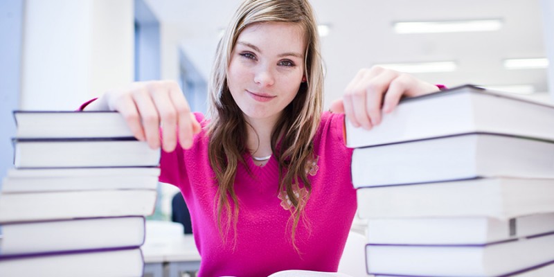 in the library – pretty, female student with laptop and books wo